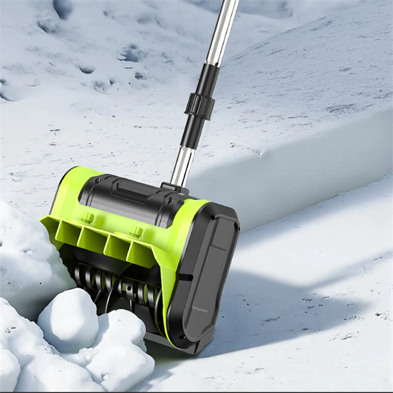 Green cordless snow shovel clearing a path through fresh snow